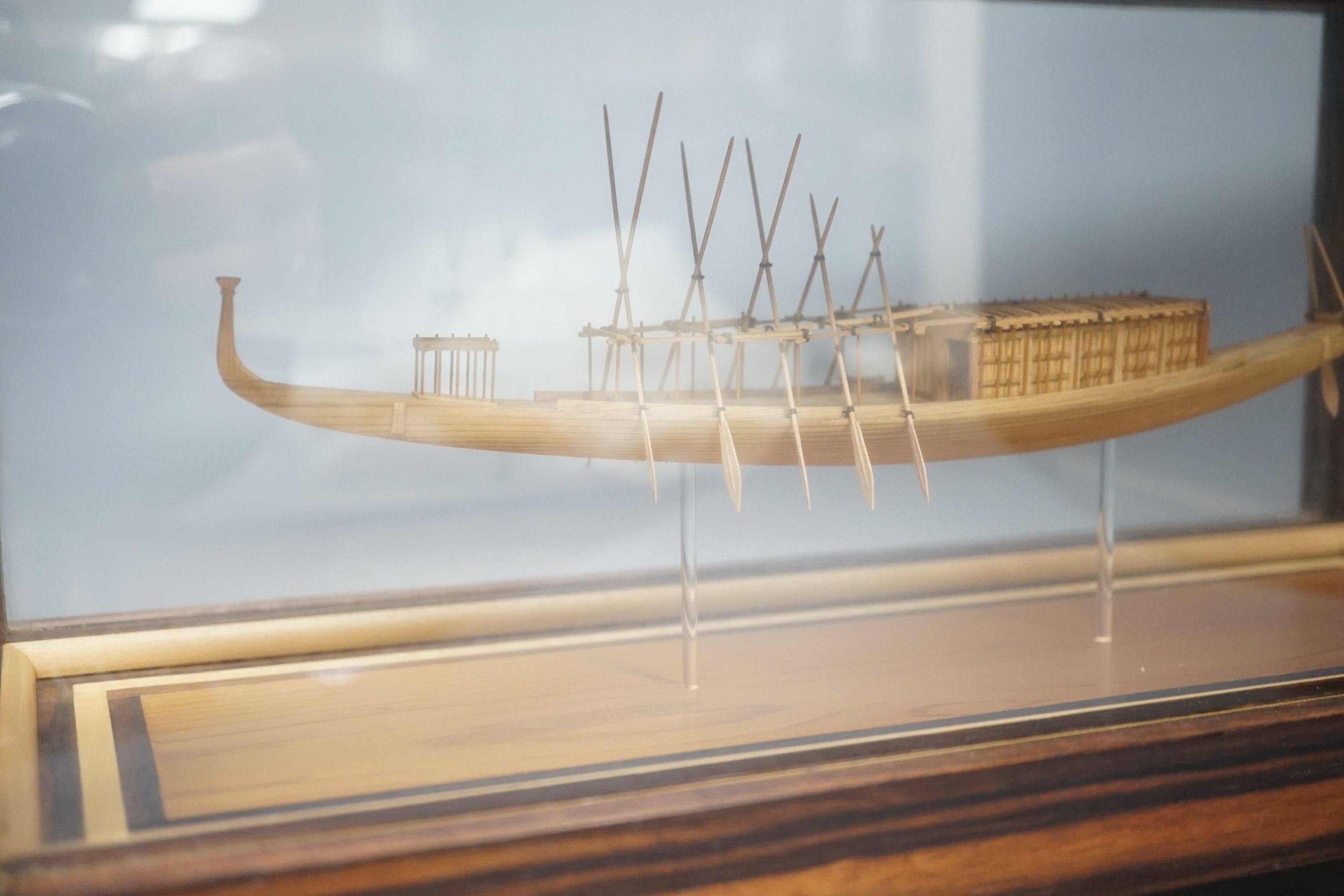 A calamander cased model of an Ancient Egyptian barge, width 42 cms